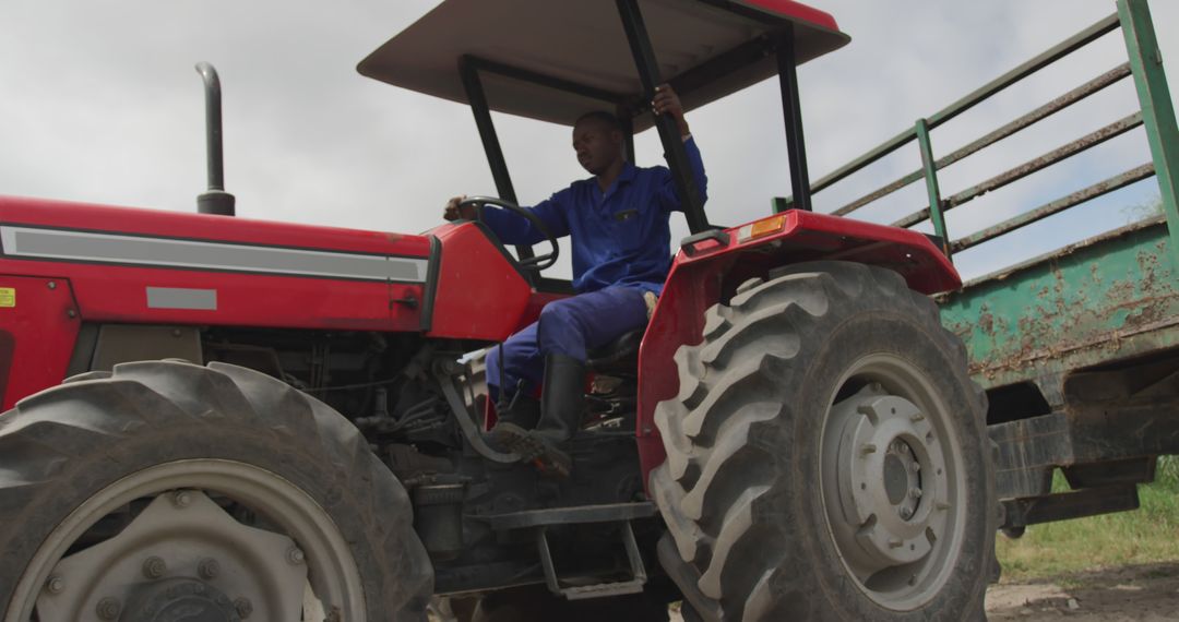 Farmer Driving Red Tractor in Agricultural Field - Free Images, Stock Photos and Pictures on Pikwizard.com