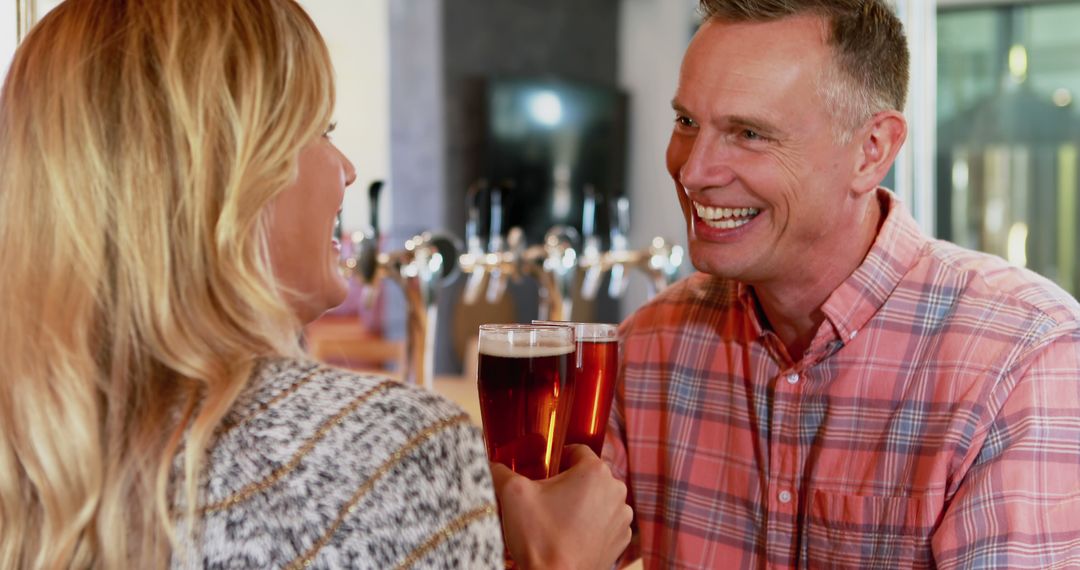 Smiling Couple Chatting and Toasting in Modern Bar