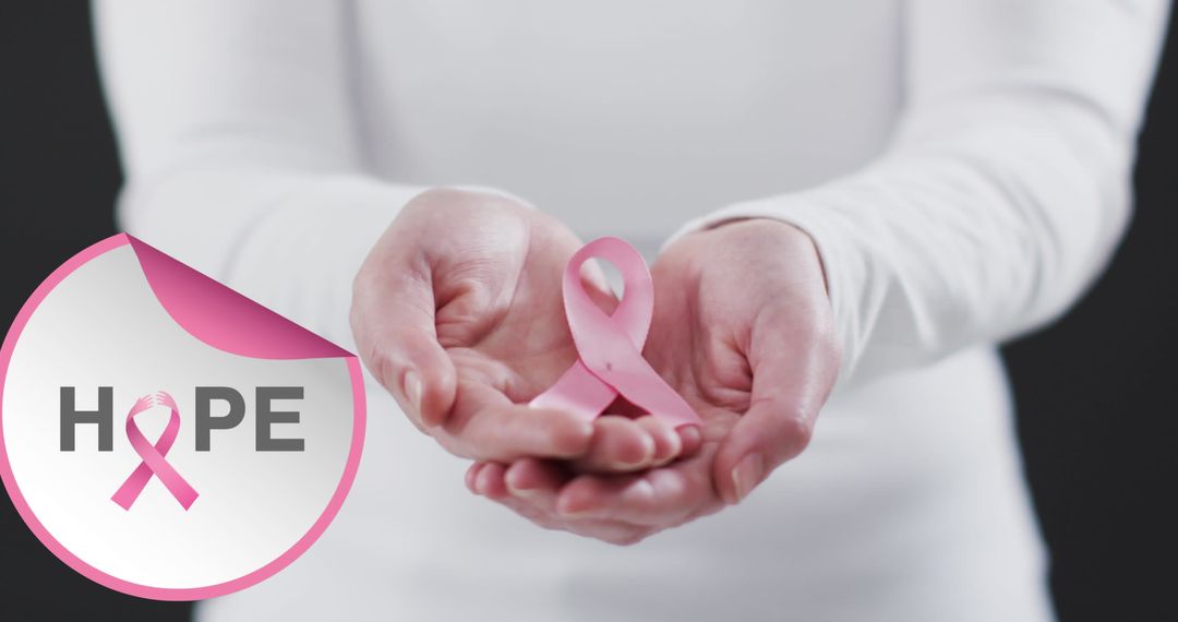 Holding Pink Ribbon for Breast Cancer Awareness with Hope Symbol