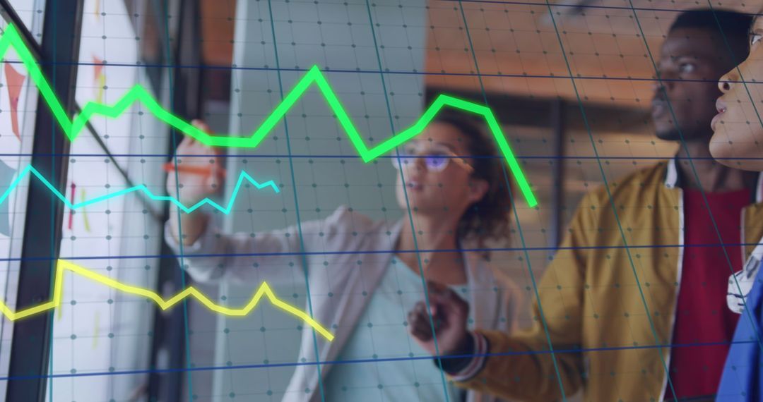 Diverse Team Analyzing Data Overlaid with Graphs in Modern Office