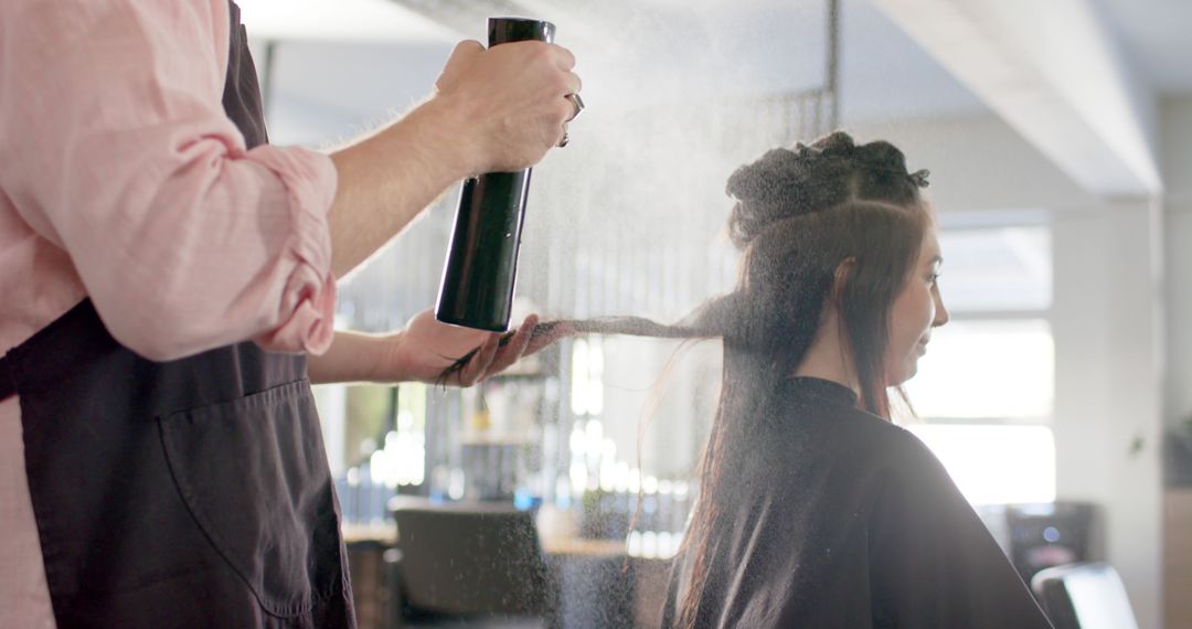 Professional Hairstylist Spraying Hair of Female Client in Salon - Free Images, Stock Photos and Pictures on Pikwizard.com