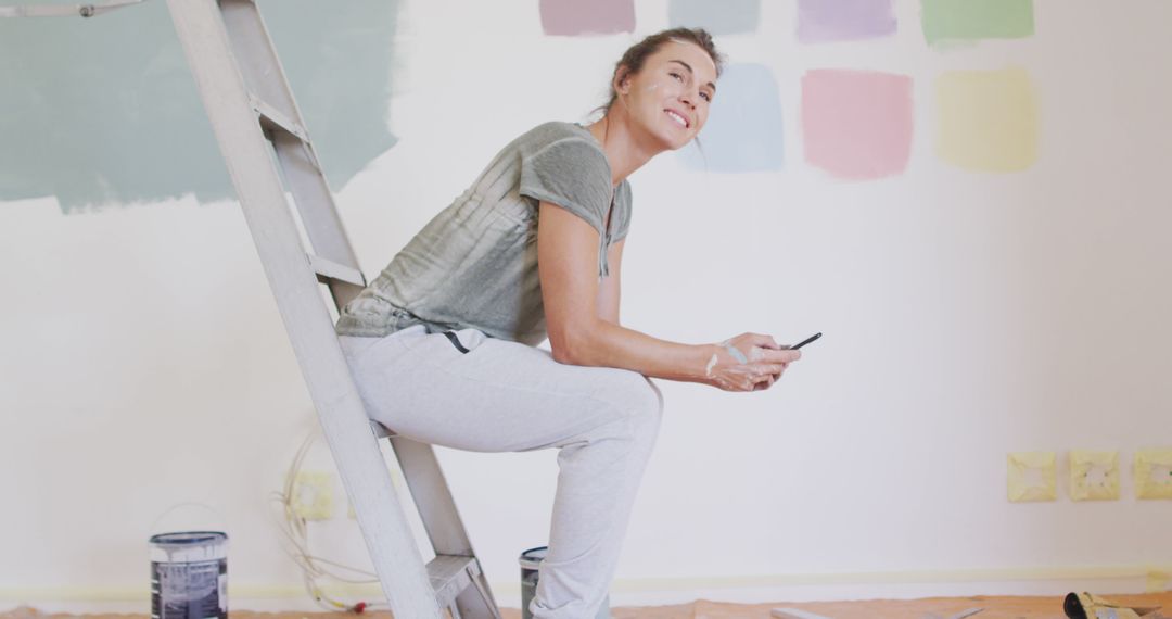 Woman Taking a Break While Painting Room - Free Images, Stock Photos and Pictures on Pikwizard.com