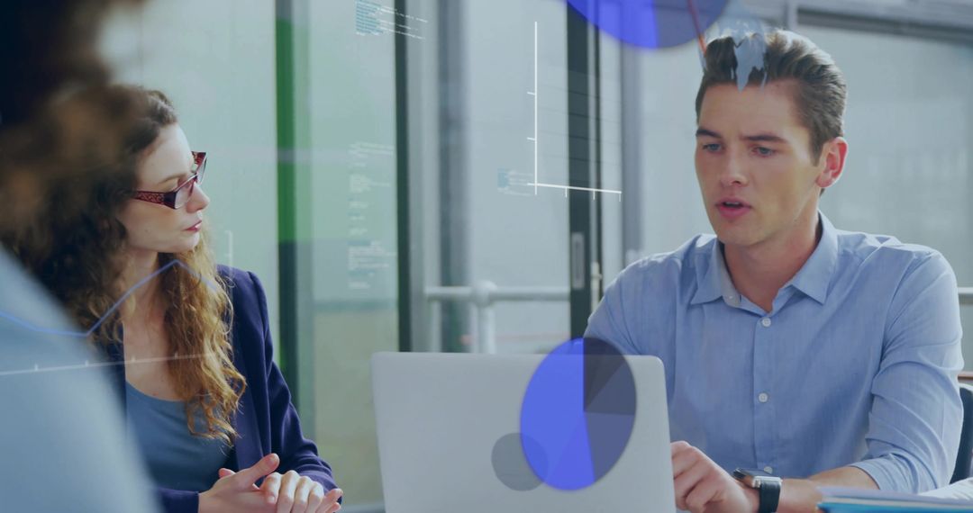 Analytics Expert Discussing Metrics with Technology Visuals in Office