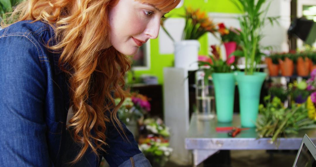 Florist with Red Hair Arranging Flowers in Shop - Free Images, Stock Photos and Pictures on Pikwizard.com