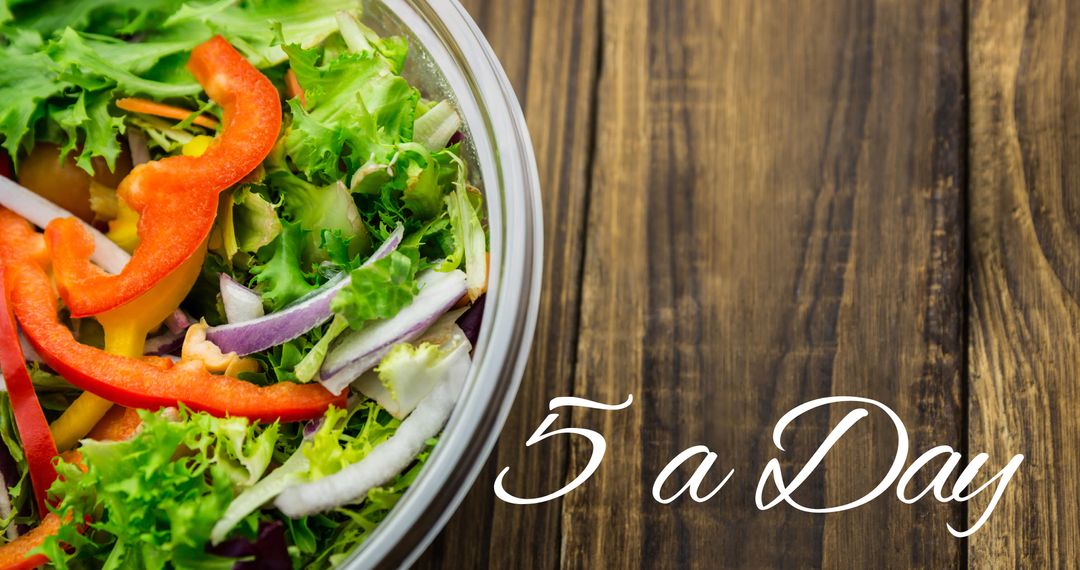 Fresh Salad Bowl with 5 a Day Message on Rustic Table