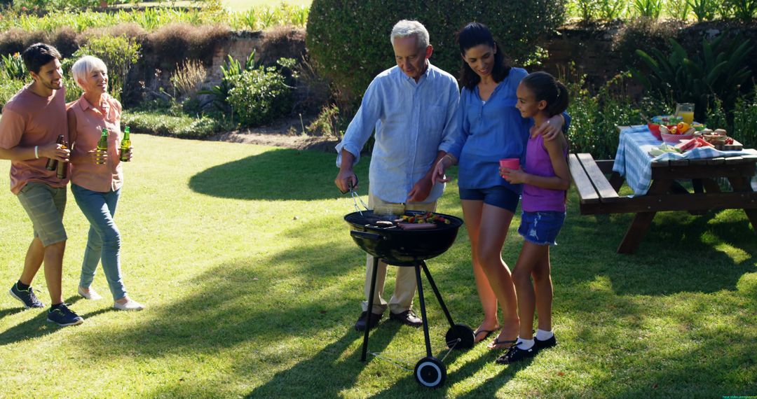 Multigenerational Family Enjoying Barbecue in Sunny Backyard - Free Images, Stock Photos and Pictures on Pikwizard.com