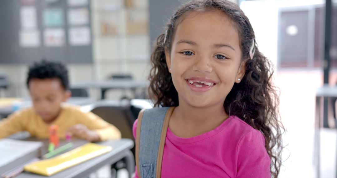 Smiling Girl in Classroom Ready for Learning with Backpack