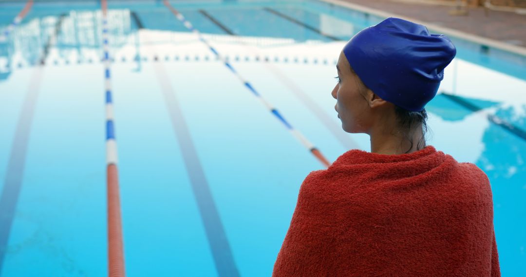 Athlete in Red Towel Observing Swimming Pool - Free Images, Stock Photos and Pictures on Pikwizard.com