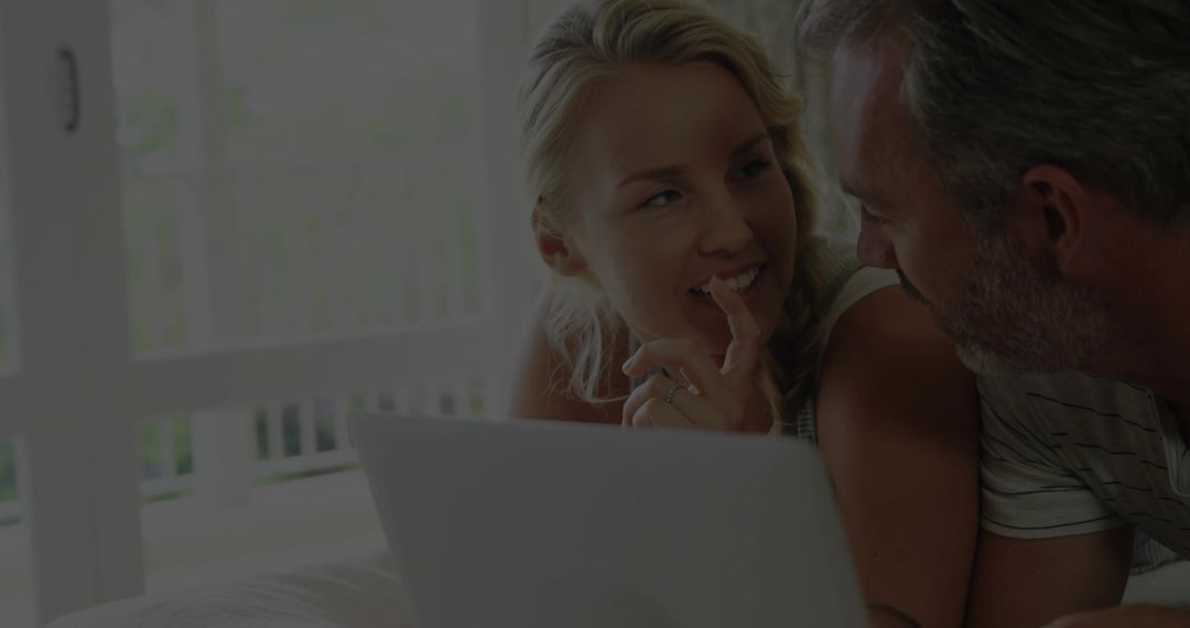 Couple Relaxing and Enjoying Conversation with Laptop by Balcony