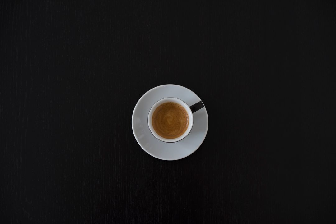 Minimalist Overhead View of Espresso on Black Background - Free Images, Stock Photos and Pictures on Pikwizard.com