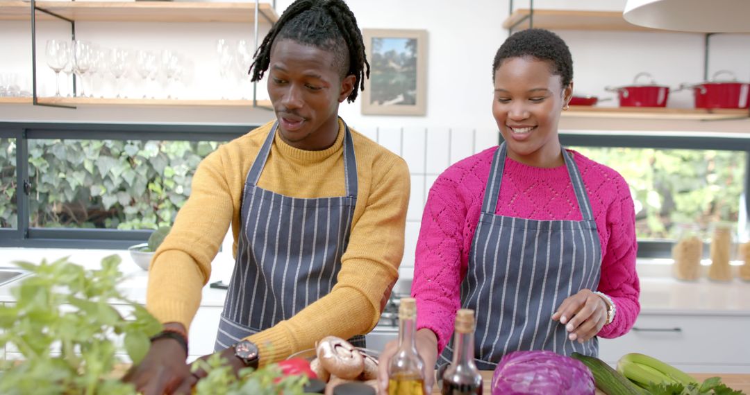 Smiling Couple in Kitchen Preparing a Meal Together