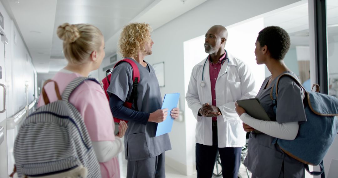 Health professionals having discussion in hospital corridor - Free Images, Stock Photos and Pictures on Pikwizard.com