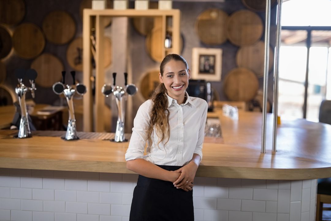 Smiling Female Bartender in Rustic Brewery Setting