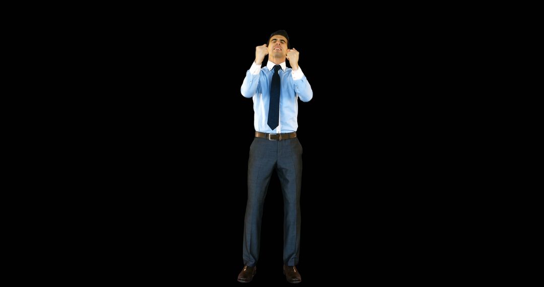 Confident Businessman in Blue Shirt Adjusting Neck Tie on Black Background - Free Images, Stock Photos and Pictures on Pikwizard.com