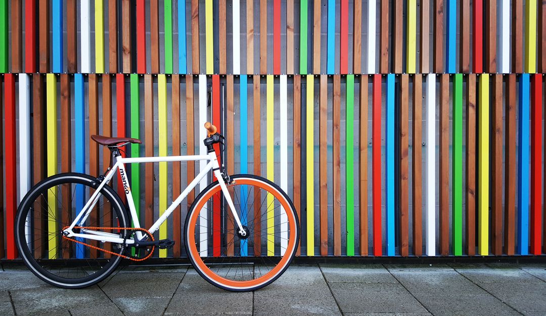 Minimalist Urban Bicycle Against Colorful Striped Wall - Free Images, Stock Photos and Pictures on Pikwizard.com