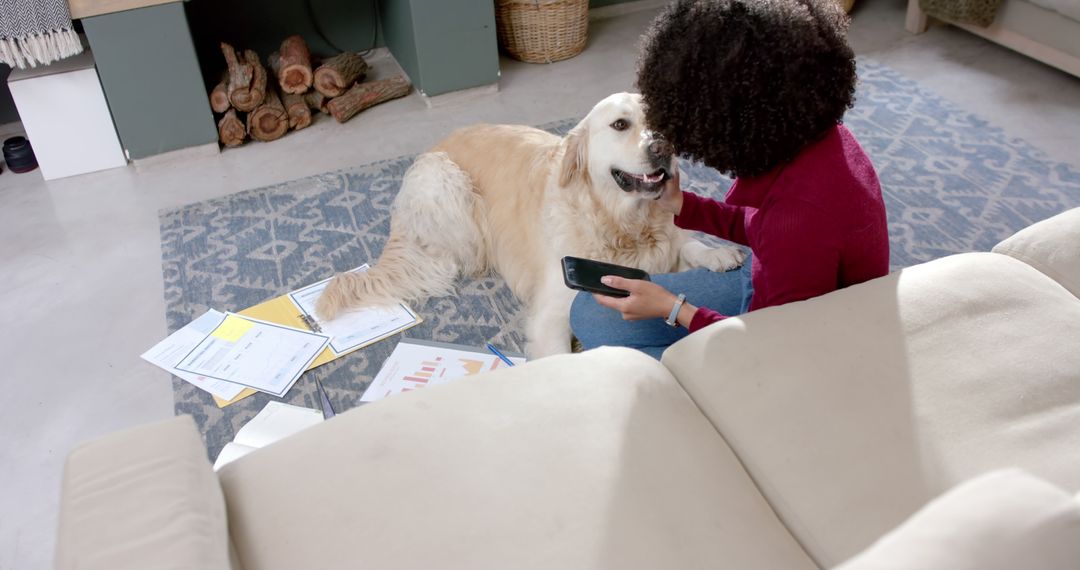 Biracial woman with golden retriever dog using smartphone at home - Free Images, Stock Photos and Pictures on Pikwizard.com