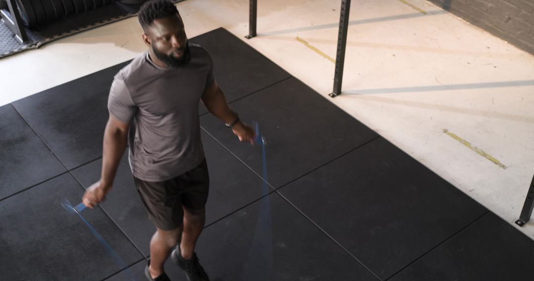 Man Skipping Rope on Gym Mat for Fitness Training