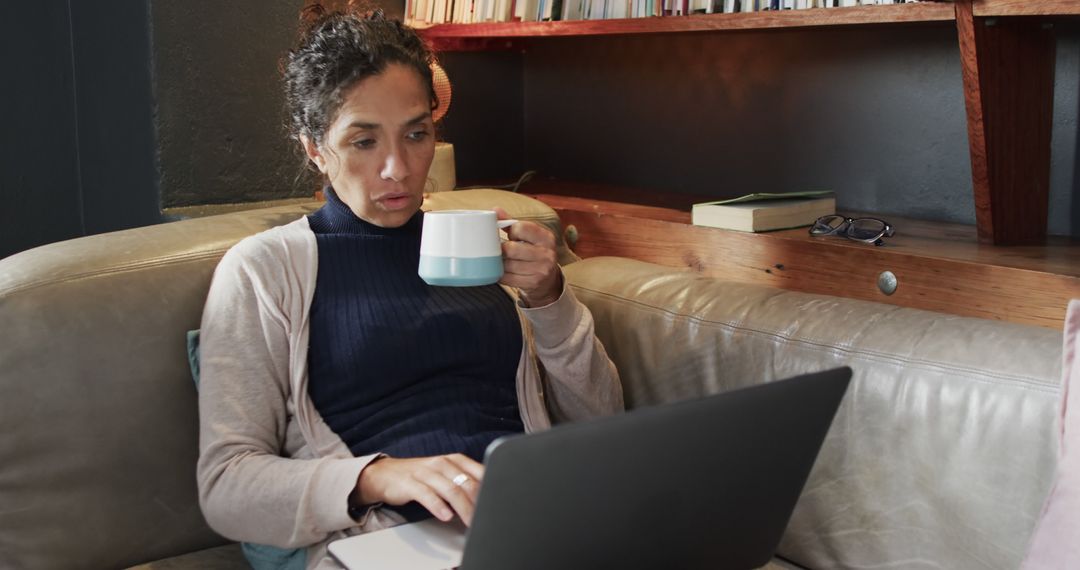 Woman Working on Laptop While Enjoying Coffee at Home - Free Images, Stock Photos and Pictures on Pikwizard.com