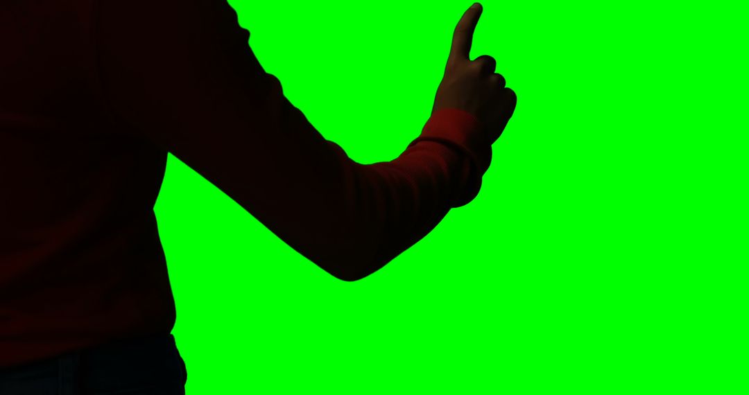Silhouette of Person Giving Thumbs-Up Against Green Screen - Free Images, Stock Photos and Pictures on Pikwizard.com