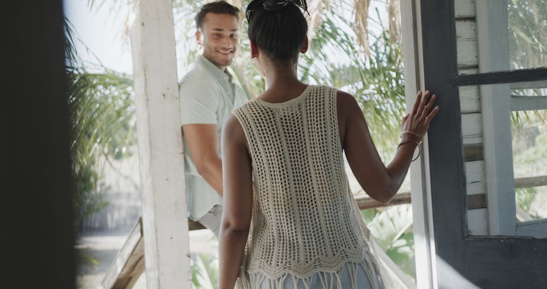 Woman Entering Tropical House Greeting Smiling Man - Free Images, Stock Photos and Pictures on Pikwizard.com