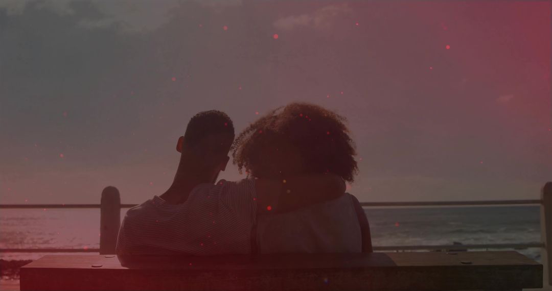 Couple Embracing on Bench Overlooking Ocean Sunset