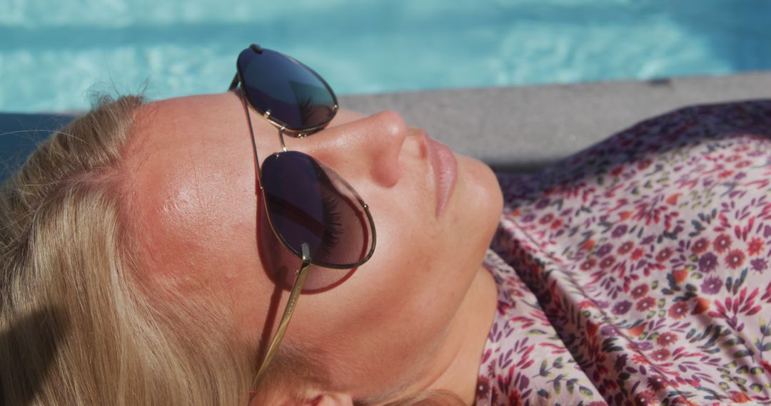 Woman Relaxing by Pool in Sunglasses and Floral Dress - Free Images, Stock Photos and Pictures on Pikwizard.com