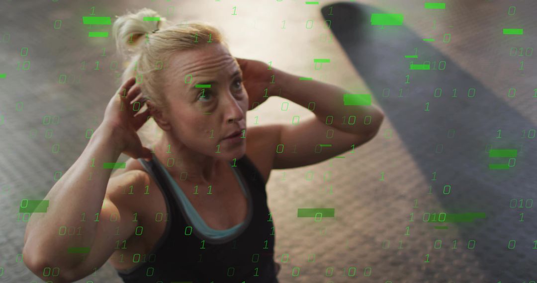 Fit woman performing crunches with green binary overlay on rubber gym floor