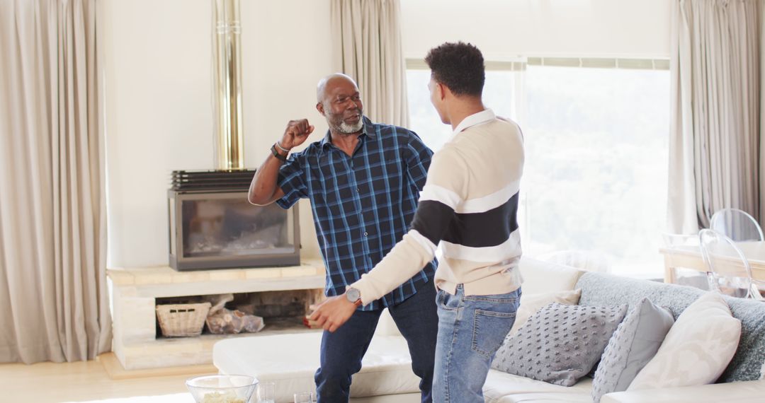 Father and Son Dancing in Living Room - Free Images, Stock Photos and Pictures on Pikwizard.com