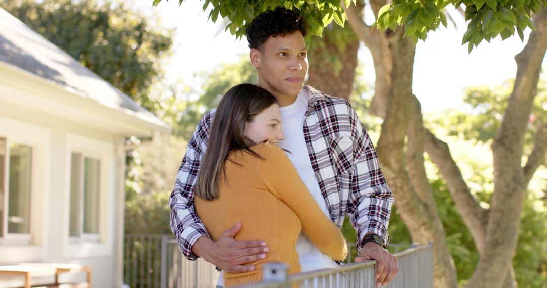 Happy Interracial Couple Embracing Outdoors in Sunny Backyard - Free Images, Stock Photos and Pictures on Pikwizard.com