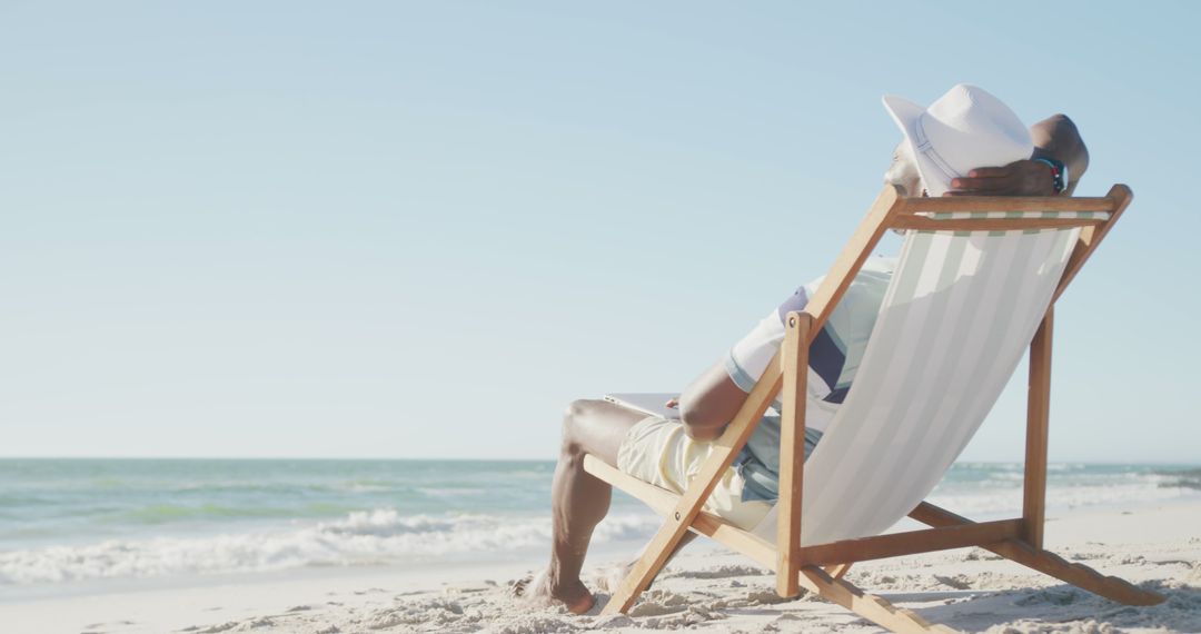 Relaxing on Beach Chair by Ocean - Free Images, Stock Photos and Pictures on Pikwizard.com