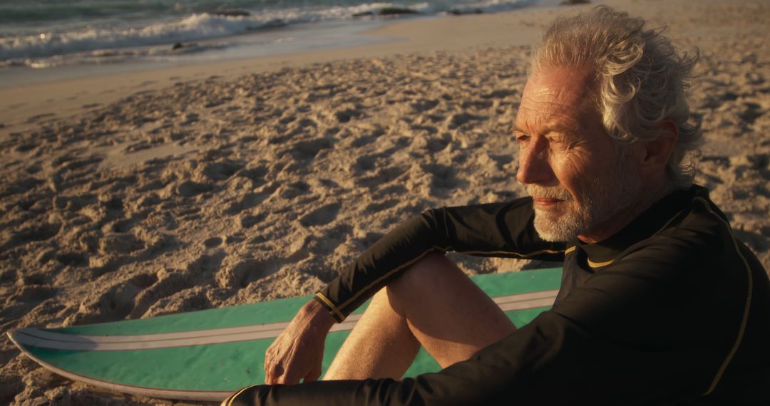 Pensive Senior Surfer Sitting on Beach at Sunset - Free Images, Stock Photos and Pictures on Pikwizard.com