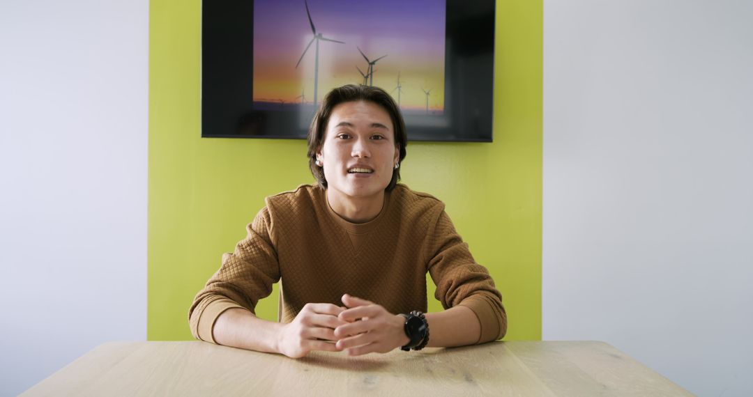 Business Professional in Green Meeting Room Discussing Tech Innovations