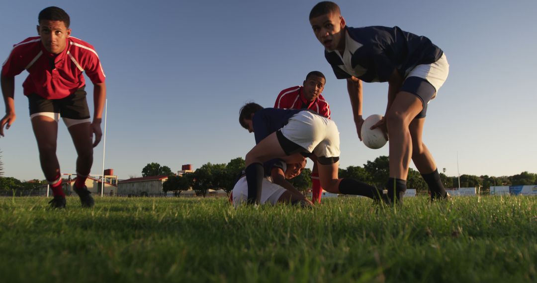 Young Men Playing Afternoon Rugby Game on Green Field - Free Images, Stock Photos and Pictures on Pikwizard.com