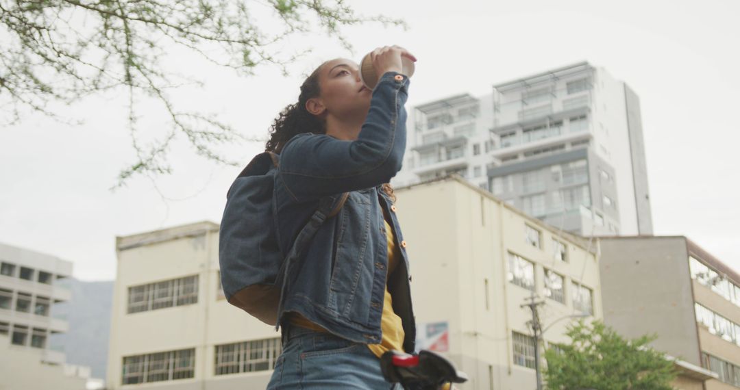 Young Woman Hydrating While Exploring Cityscape Outdoors - Free Images, Stock Photos and Pictures on Pikwizard.com