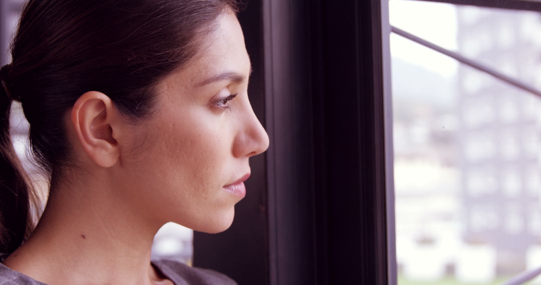 Thoughtful Businesswoman Looking Through Window