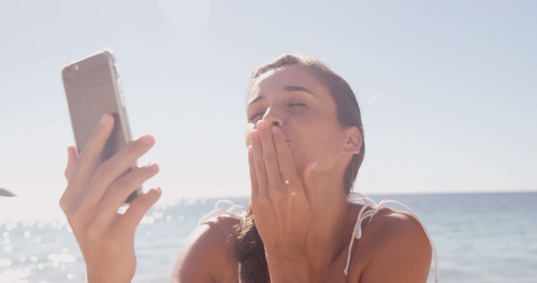 Woman Sending Goodbye Kiss on Video Call at Beach - Free Images, Stock Photos and Pictures on Pikwizard.com