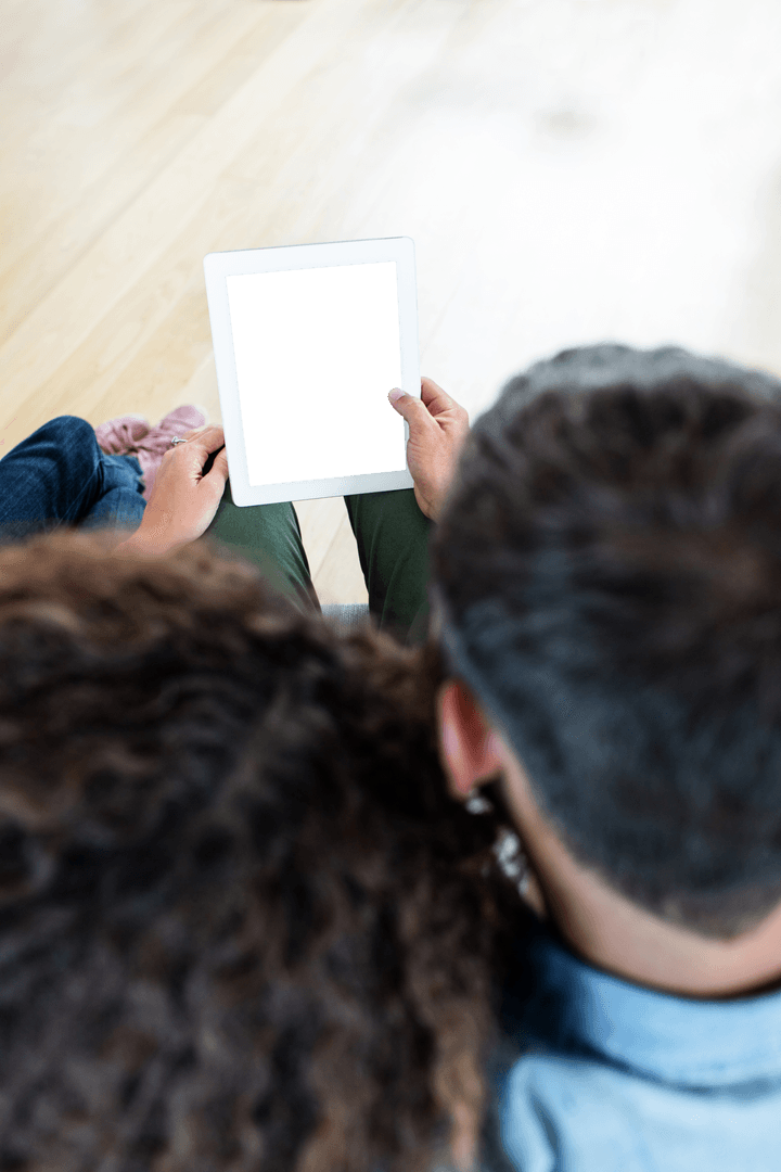 Couple Interacting with Transparent Tablet Screen at Home