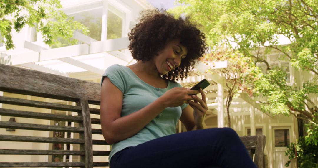 Woman Texting on Smartphone Outdoors on Bench - Free Images, Stock Photos and Pictures on Pikwizard.com