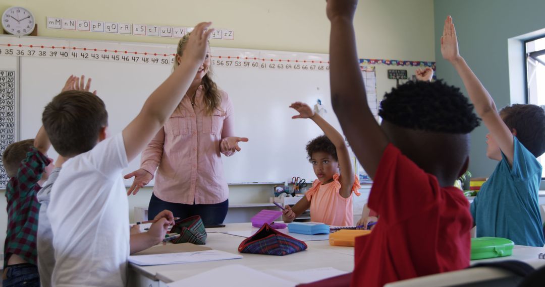 Diverse Group of Kids Raising Hands in Classroom - Free Images, Stock Photos and Pictures on Pikwizard.com