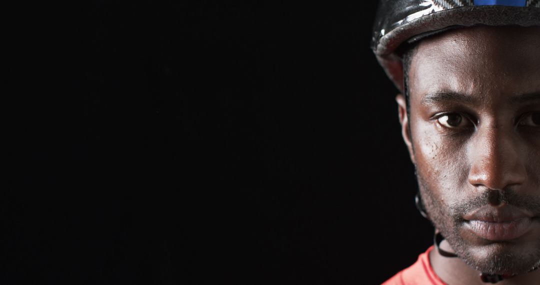 Focused Cyclist Wearing Helmet Against Dark Background