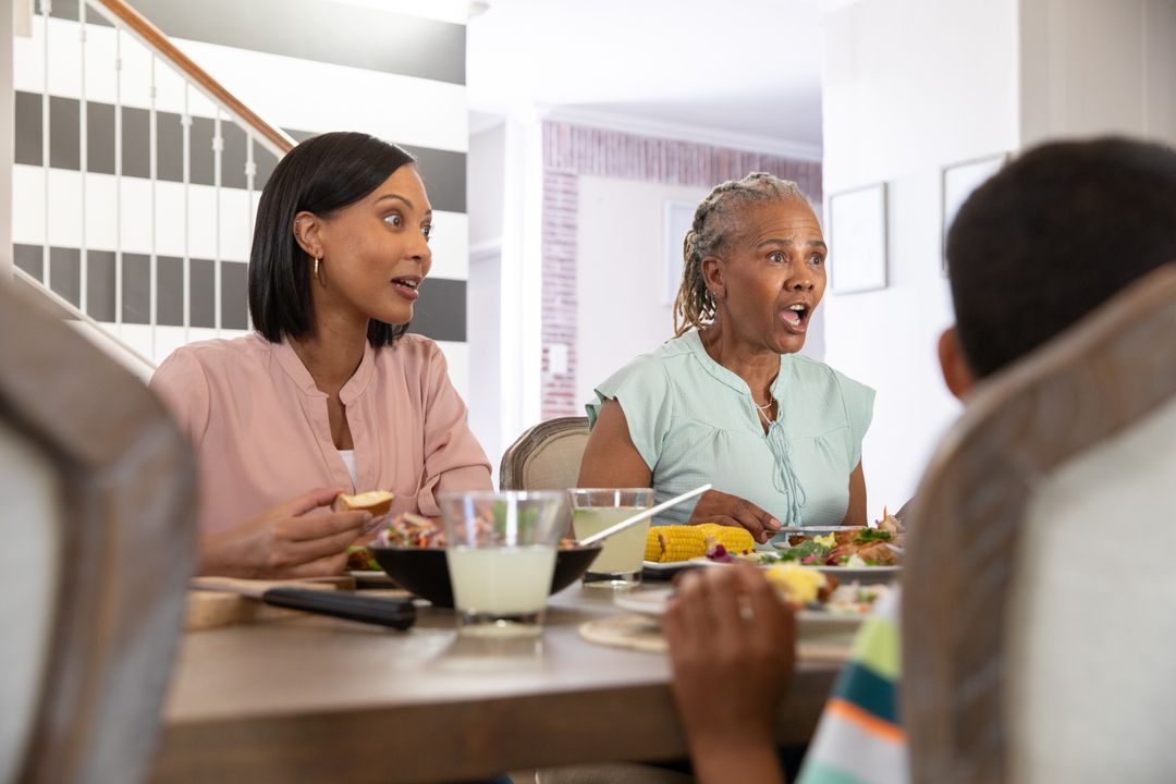 Surprised Generational Family Sharing Meal Around Dining Table
