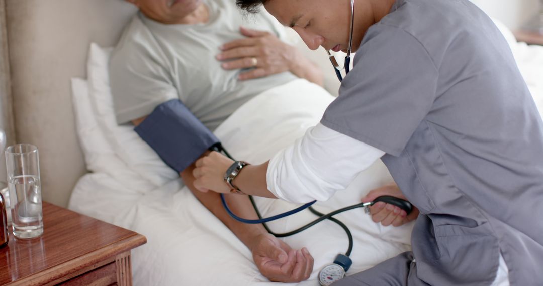 Healthcare worker measuring patient's blood pressure in home setting - Free Images, Stock Photos and Pictures on Pikwizard.com