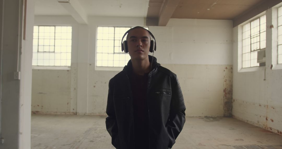 Young Man Listening to Music in Abandoned Building - Free Images, Stock Photos and Pictures on Pikwizard.com