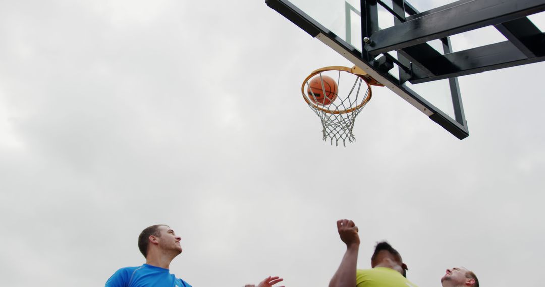 Diverse Basketball Players Scoring on Court