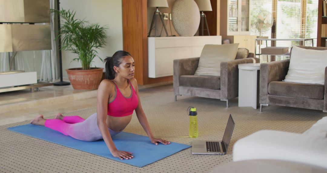 Focused Woman Practicing Yoga at Home with Online Workout - Free Images, Stock Photos and Pictures on Pikwizard.com