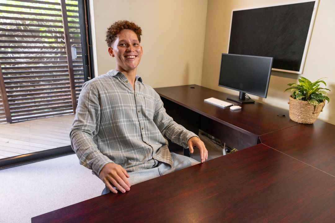 Smiling Man Working from Home Office in Casual Attire