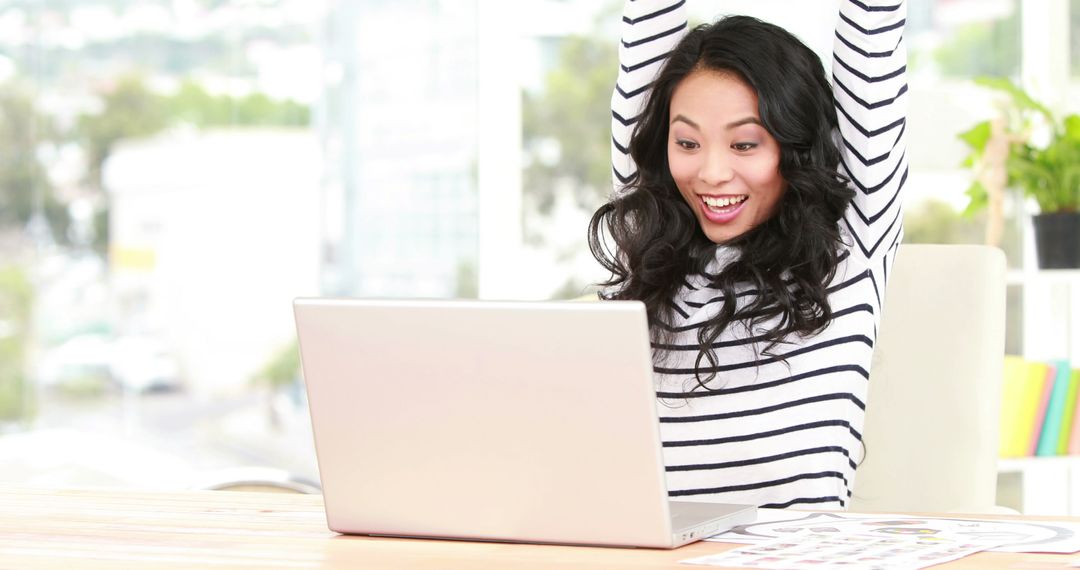 Excited Woman Celebrating Success in Front of Laptop - Free Images, Stock Photos and Pictures on Pikwizard.com