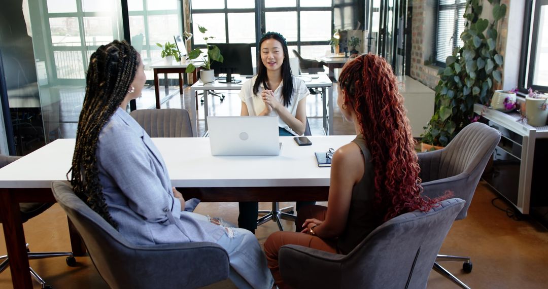Diverse Female Team Collaborating on Work Project in Modern Office