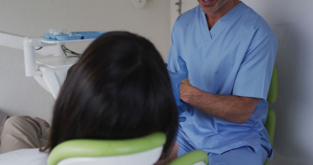 Dentist Interacting with Patient at Dental Office - Free Images, Stock Photos and Pictures on Pikwizard.com