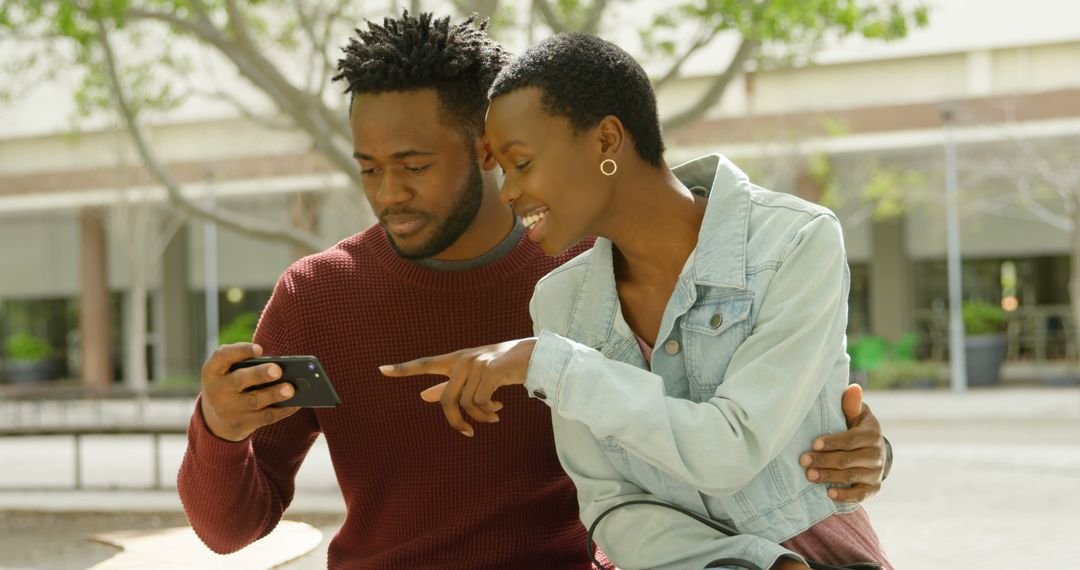 Young Couple Enjoying Moment Using Smartphone Outdoors